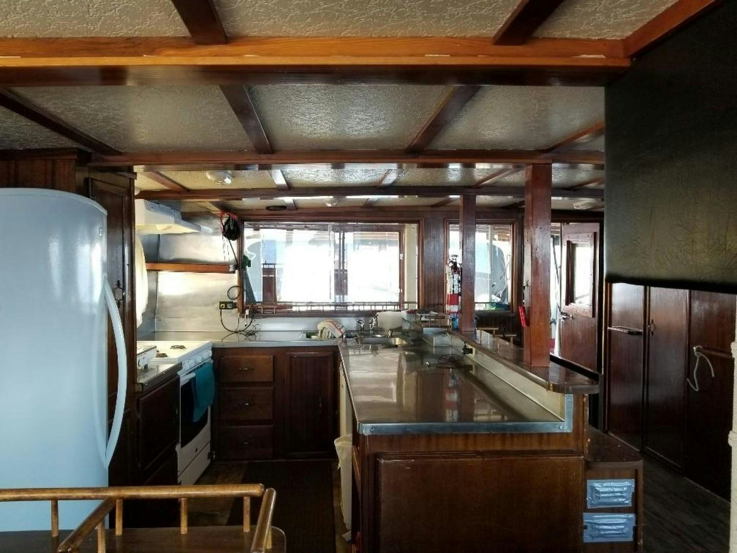 a kitchen with a large window aboard LAURA MARIE Yacht for Sale