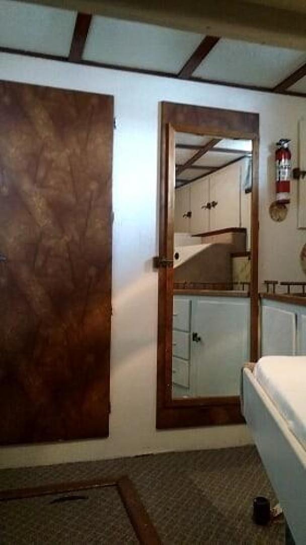 a bathroom with a wooden door aboard LAURA MARIE Yacht for Sale