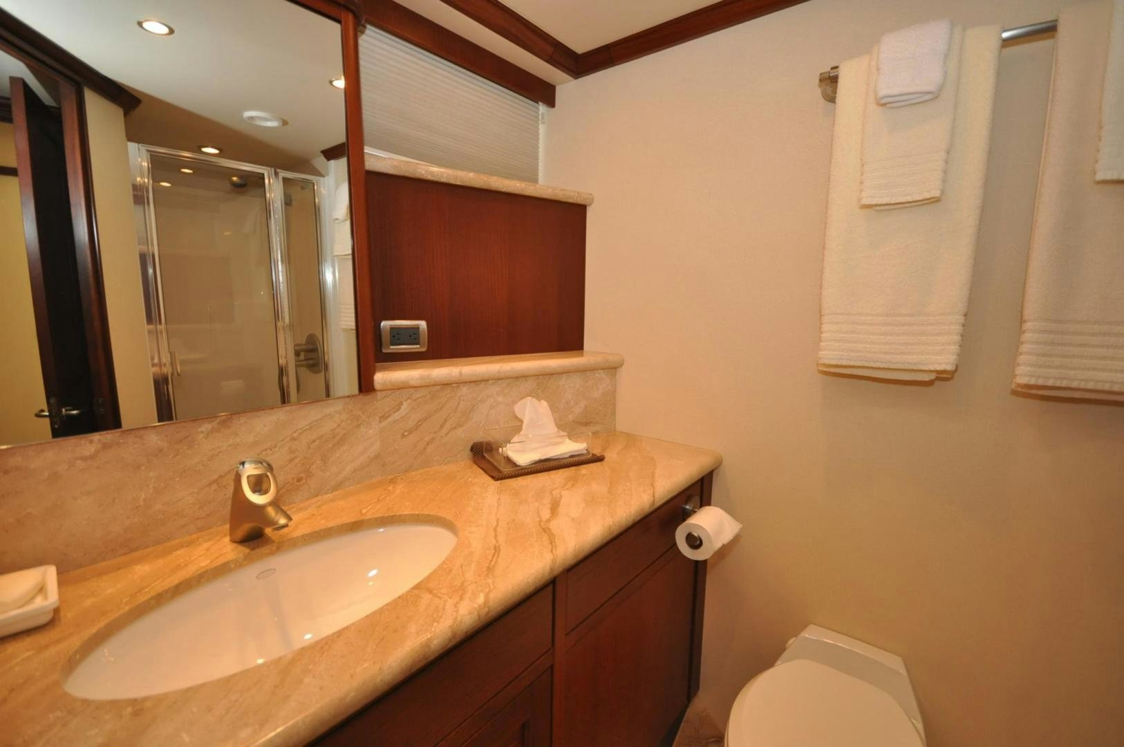 a bathroom with a sink and a mirror aboard LUCK A LEE IV Yacht for Sale