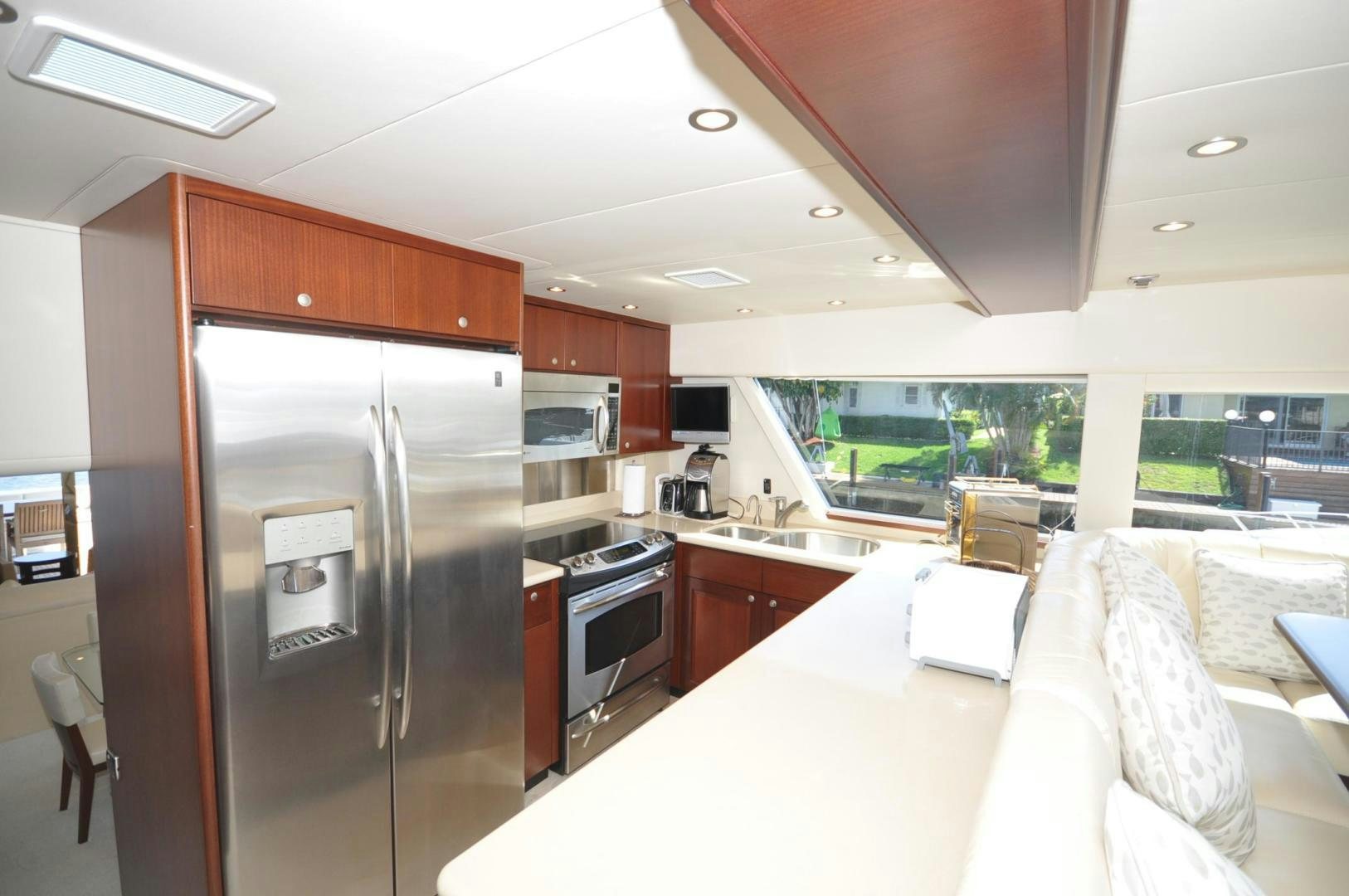a kitchen with a refrigerator and a table aboard LUCK A LEE IV Yacht for Sale