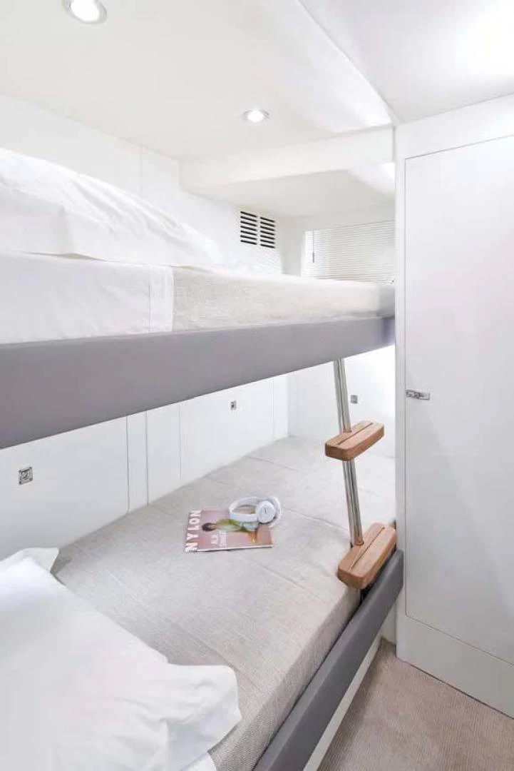 a white bedroom with a white bed aboard Y85 Yacht for Sale