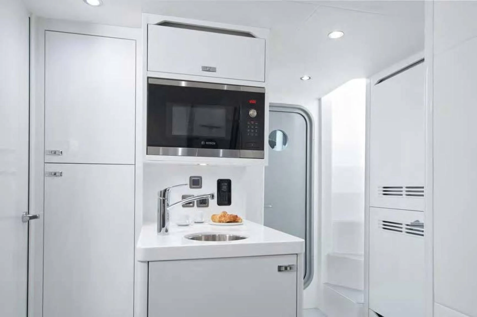 a white kitchen with white cabinets aboard Y85 Yacht for Sale