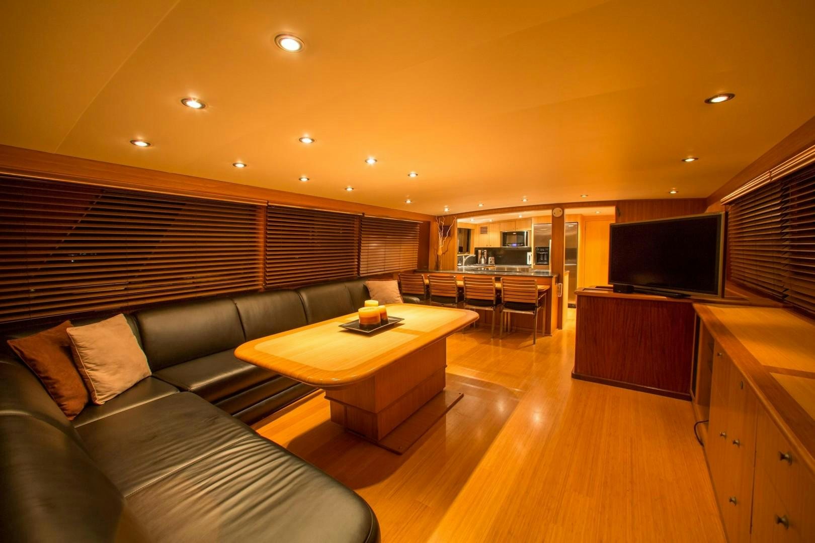 a living room with a wood floor aboard CATCHIN FEELINGS Yacht for Sale