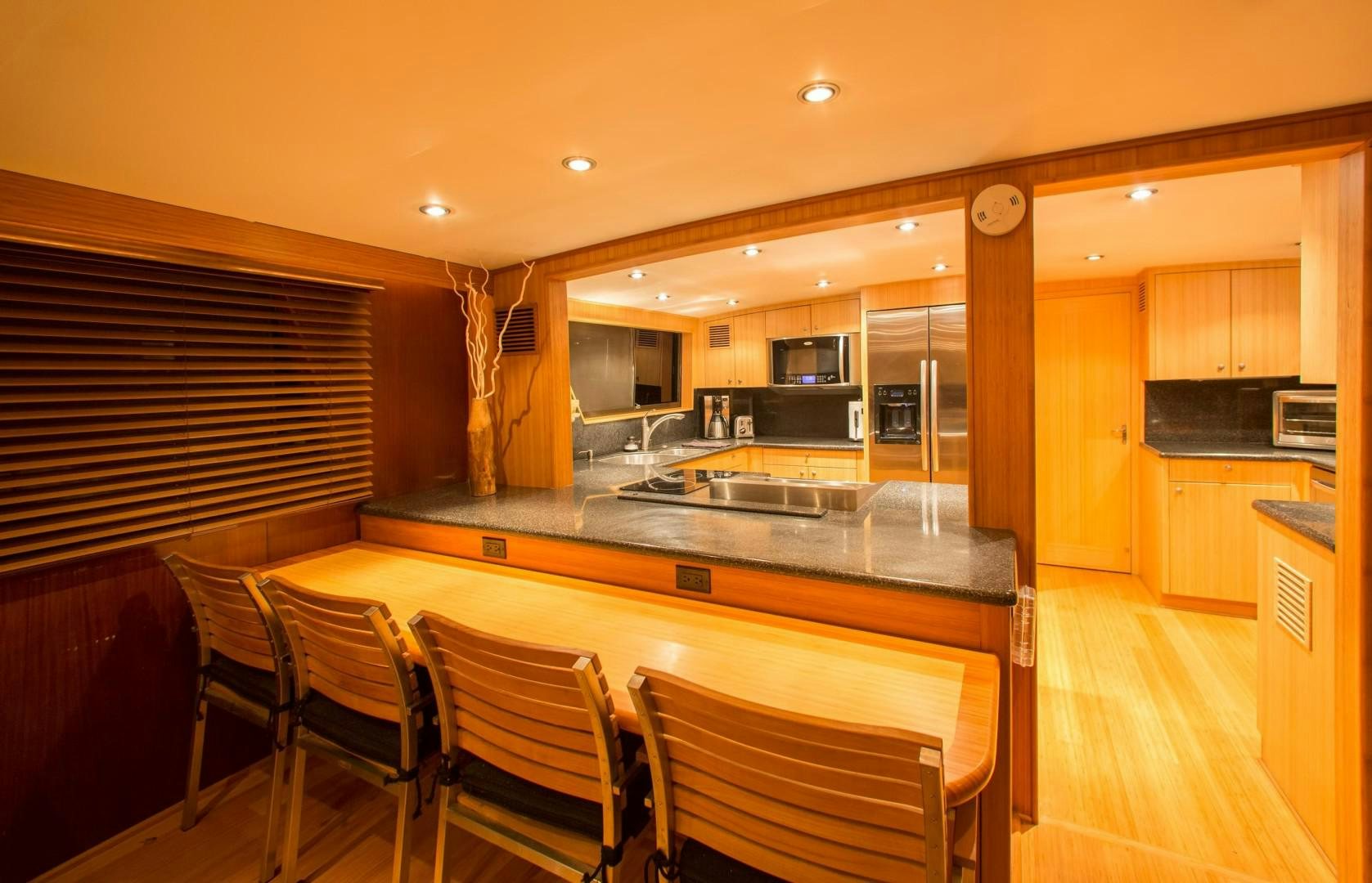 a kitchen with a table and chairs aboard CATCHIN FEELINGS Yacht for Sale