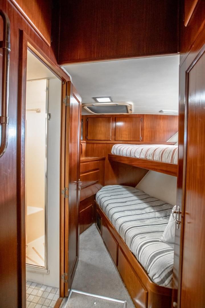 a room with a bed and a closet aboard CATCHIN FEELINGS Yacht for Sale