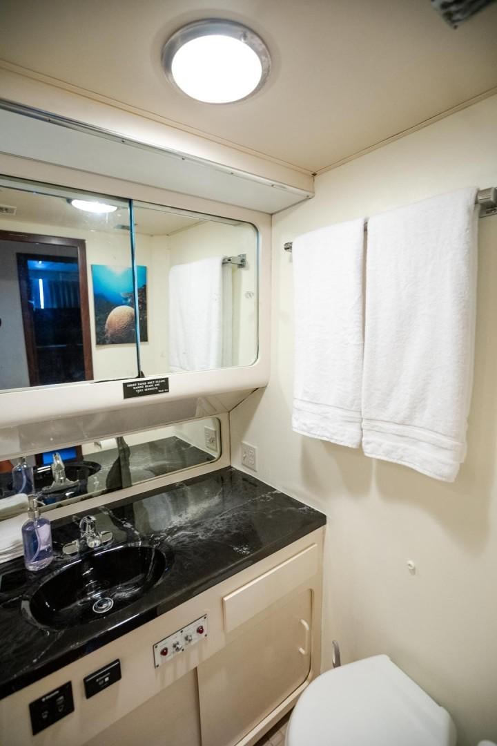 a bathroom with a sink and a mirror aboard CATCHIN FEELINGS Yacht for Sale