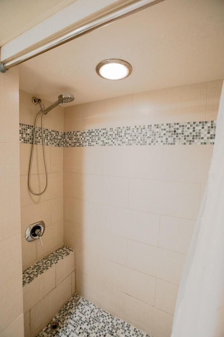 a shower with a tile floor aboard CATCHIN FEELINGS Yacht for Sale
