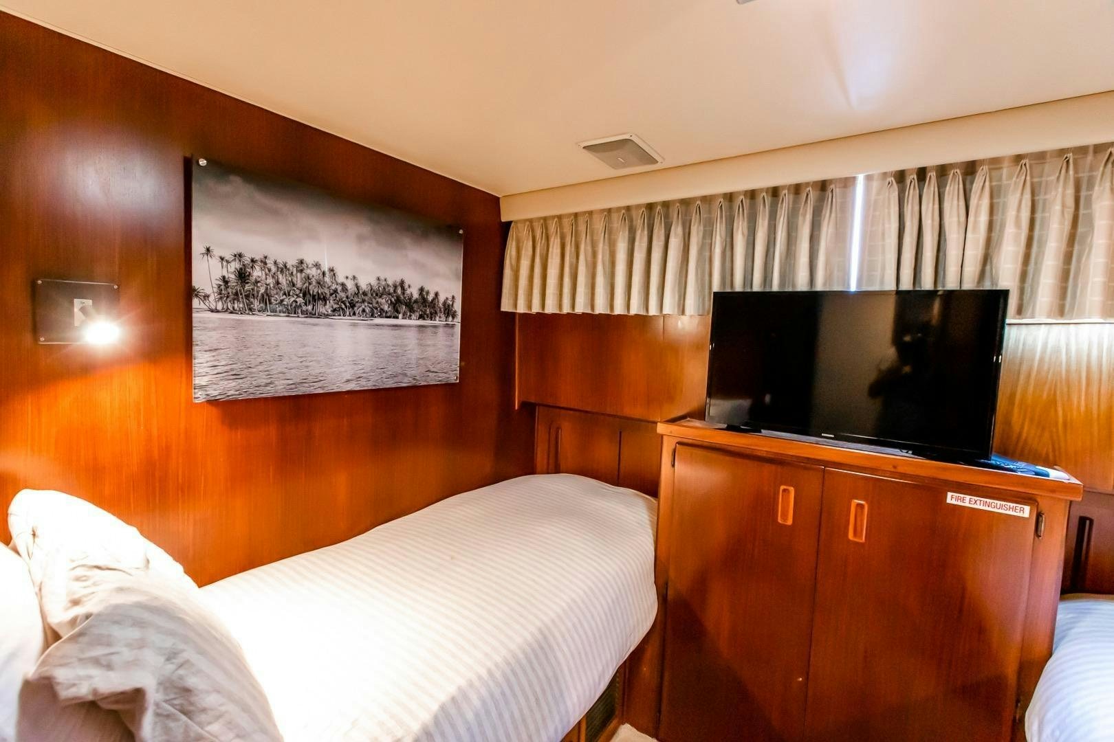 a bedroom with a tv on the wall aboard CATCHIN FEELINGS Yacht for Sale
