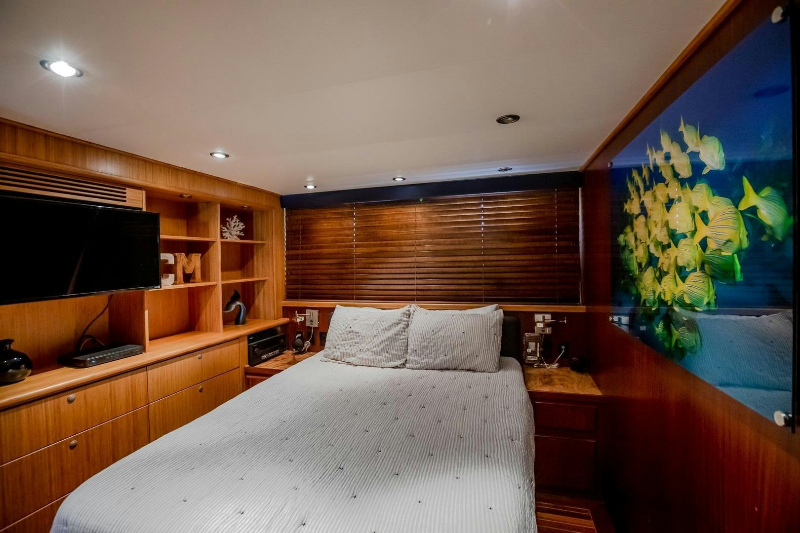 a bedroom with a large painting aboard CATCHIN FEELINGS Yacht for Sale