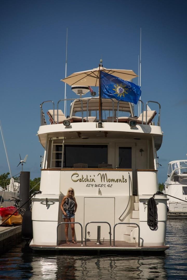 a boat with a person standing on the deck aboard CATCHIN FEELINGS Yacht for Sale