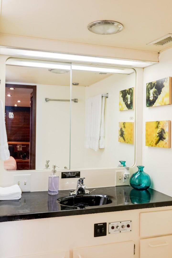 a bathroom with a sink and a mirror aboard CATCHIN FEELINGS Yacht for Sale