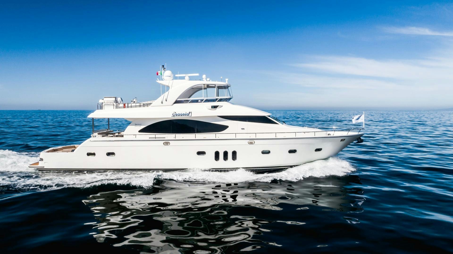 a white yacht on the water aboard FULL HOUSE Yacht for Sale