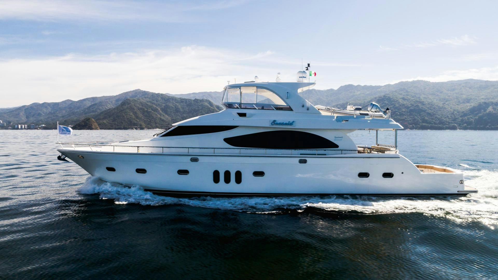 a white yacht on the water aboard FULL HOUSE Yacht for Sale