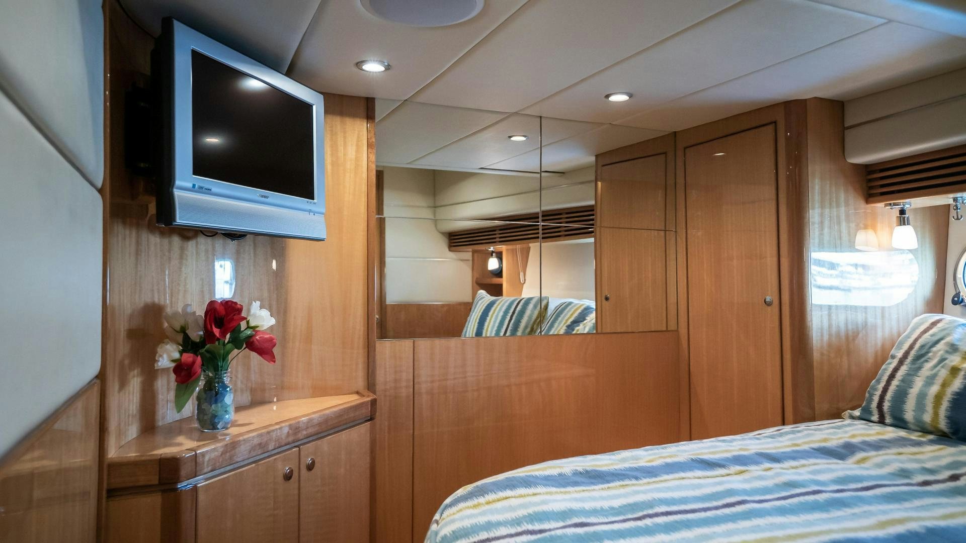 a room with a bed and a tv aboard FULL HOUSE Yacht for Sale