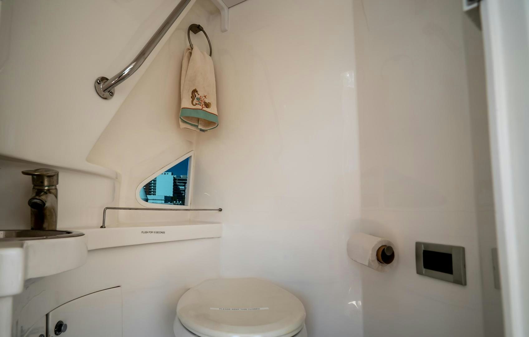 a bathroom with a mirror and toilet aboard FULL HOUSE Yacht for Sale