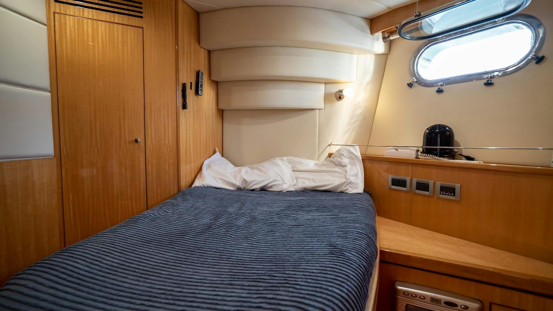 a bed with a helmet on top aboard FULL HOUSE Yacht for Sale