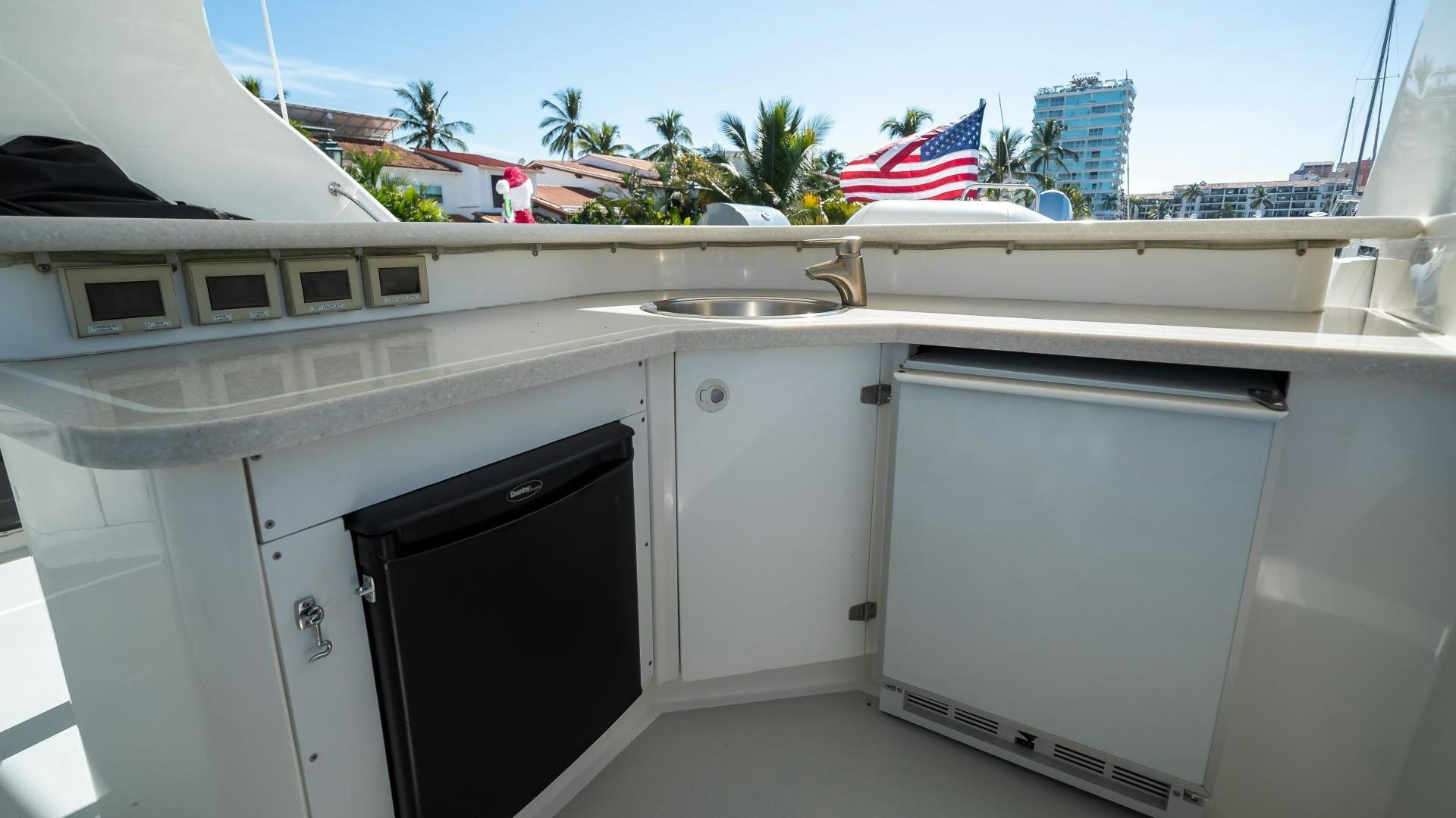 a large white boat with a black door and a black rectangular object on the side aboard FULL HOUSE Yacht for Sale