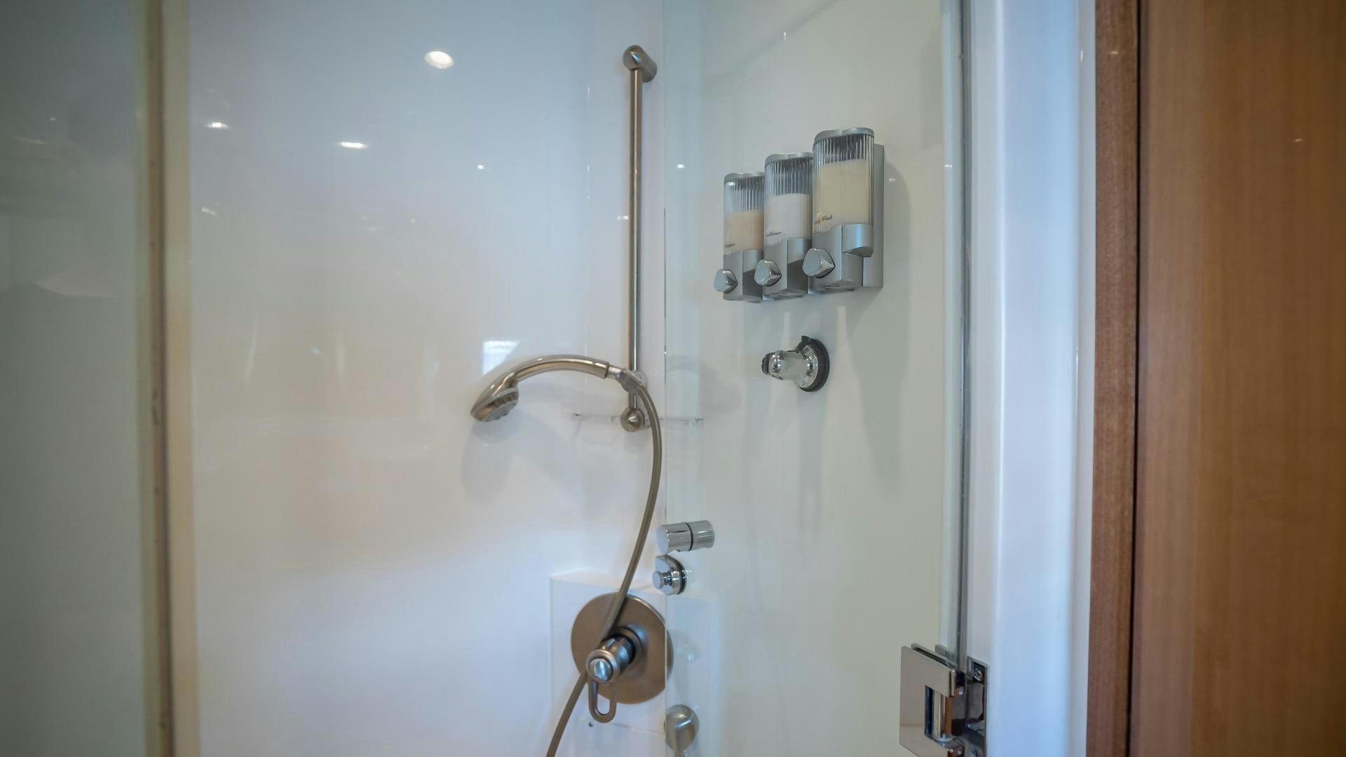 a white bathtub with a shower head and a metal faucet aboard FULL HOUSE Yacht for Sale