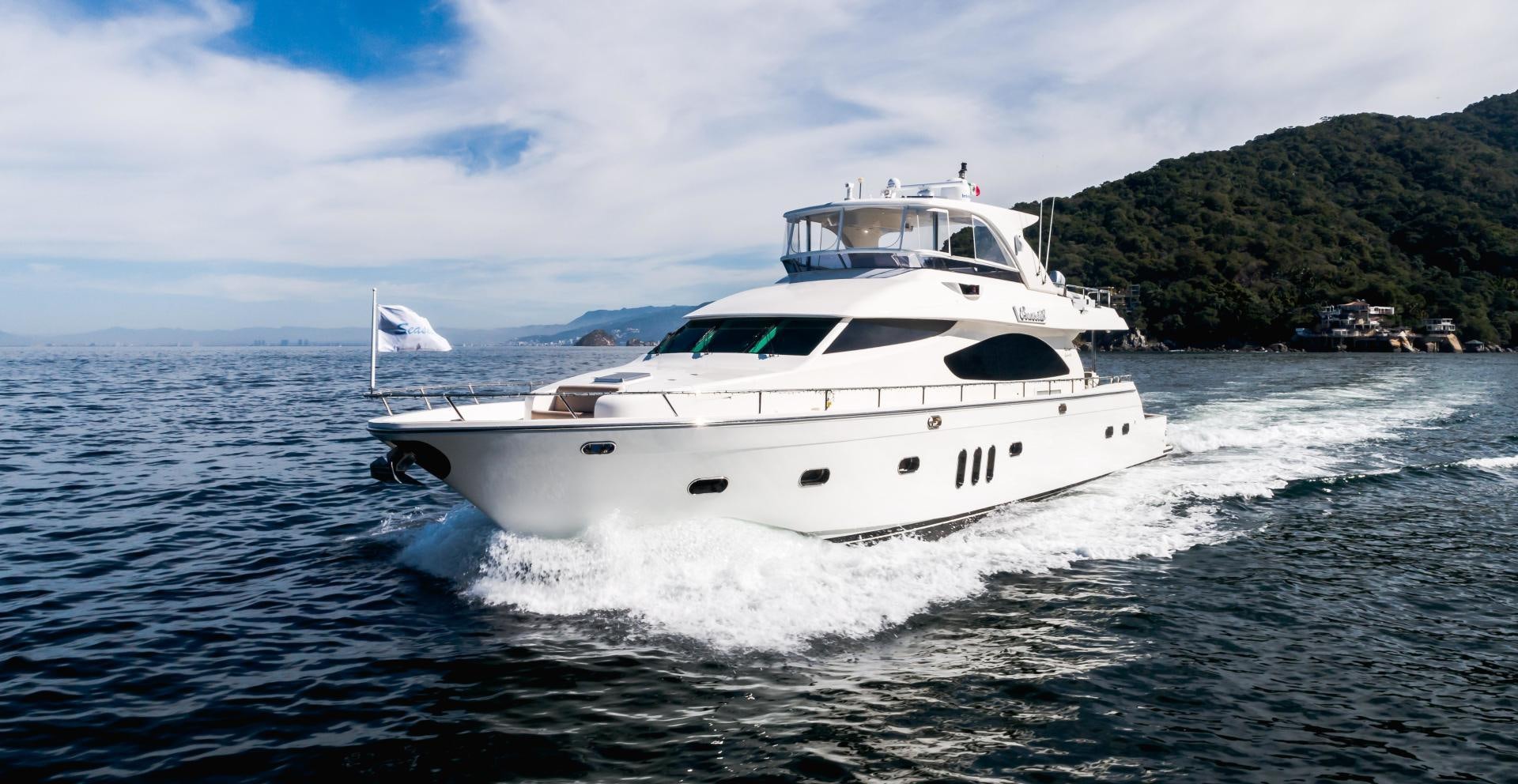 a white yacht on the water aboard FULL HOUSE Yacht for Sale