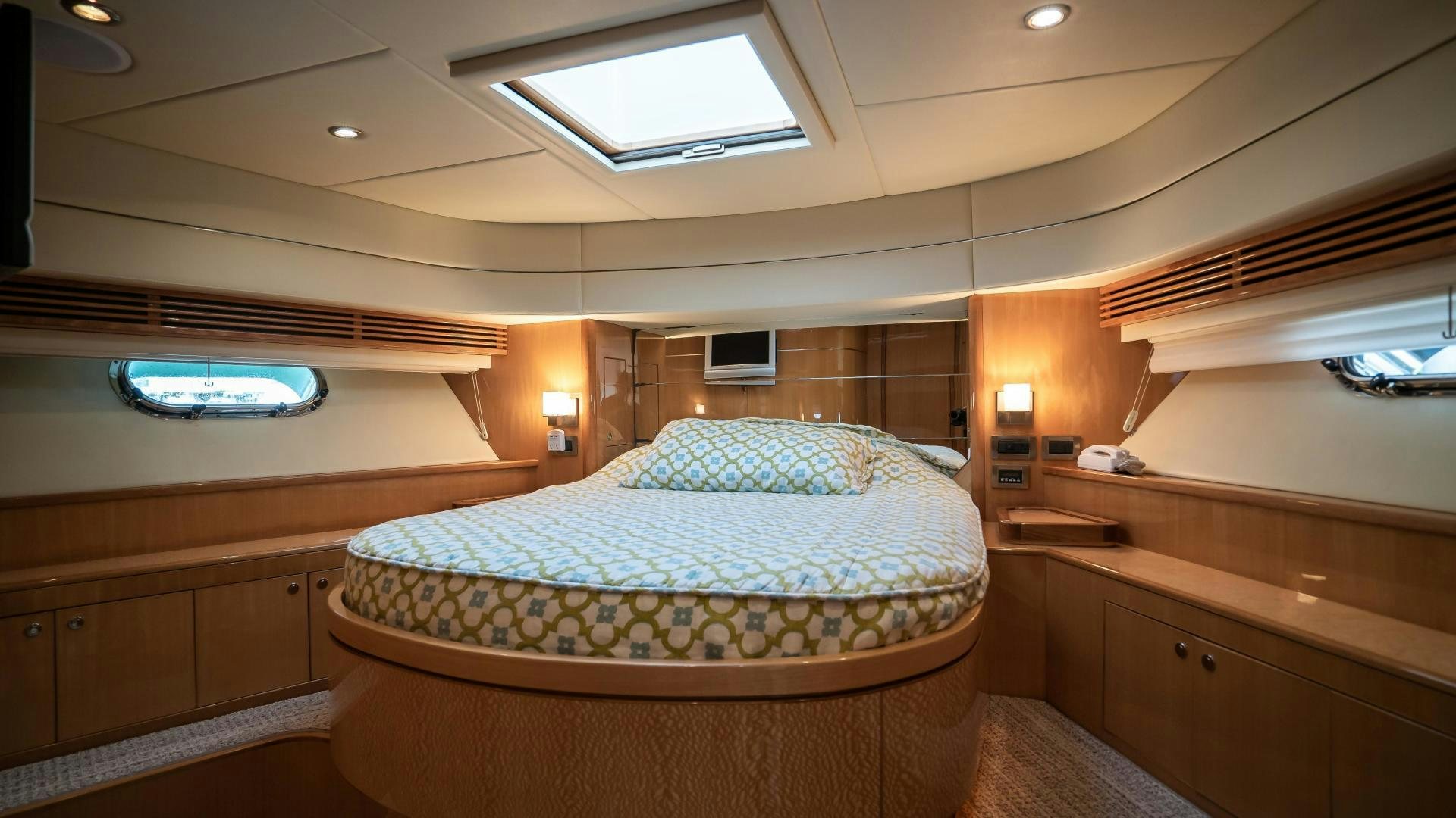 a room with a bed and a window aboard FULL HOUSE Yacht for Sale
