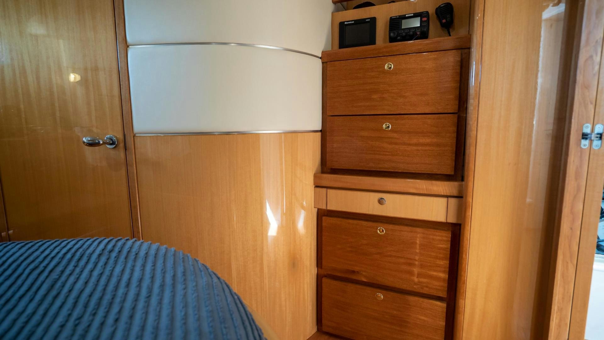 a dresser and a bed in a room aboard FULL HOUSE Yacht for Sale