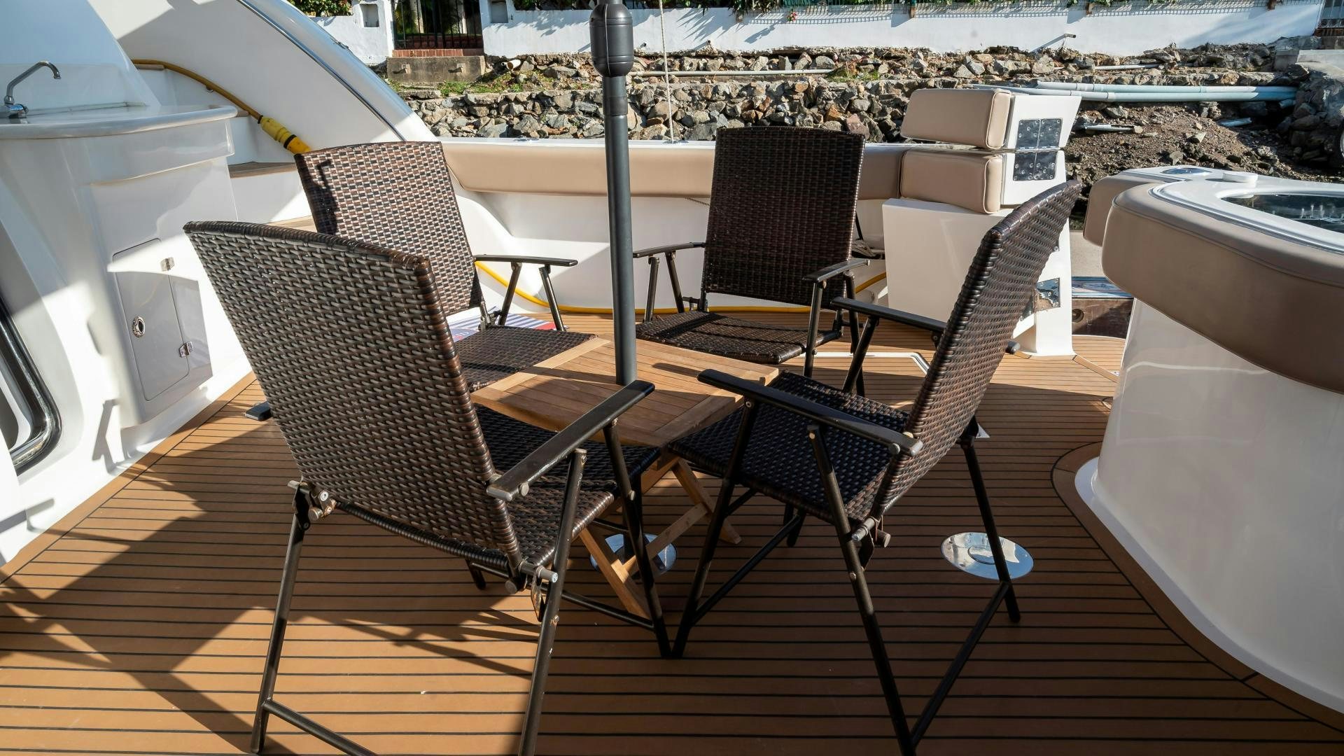 a deck with chairs and tables aboard FULL HOUSE Yacht for Sale