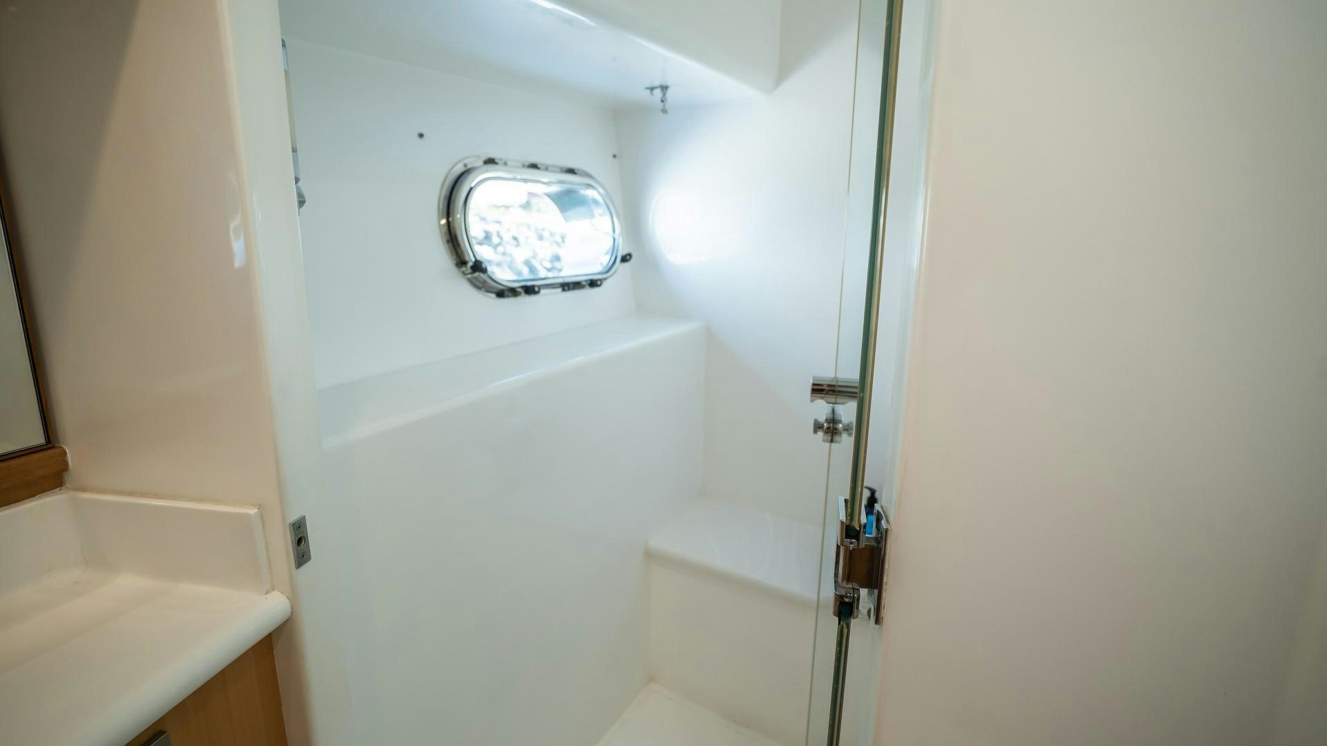a small bathroom with a sink and a mirror aboard FULL HOUSE Yacht for Sale