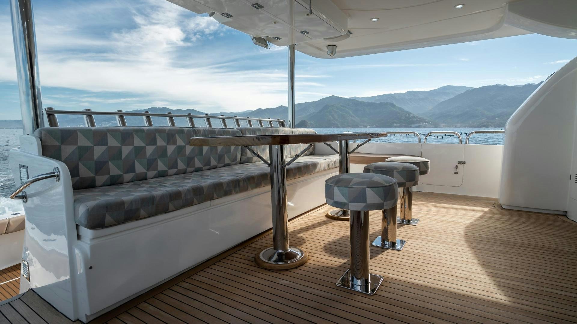 a couch and chairs on a deck aboard FULL HOUSE Yacht for Sale