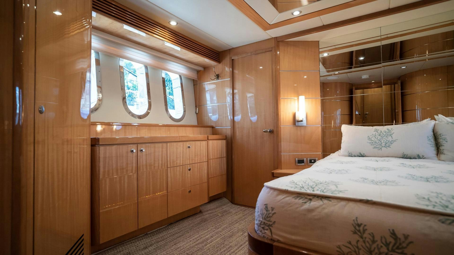 a room with a bed and a wooden closet aboard FULL HOUSE Yacht for Sale