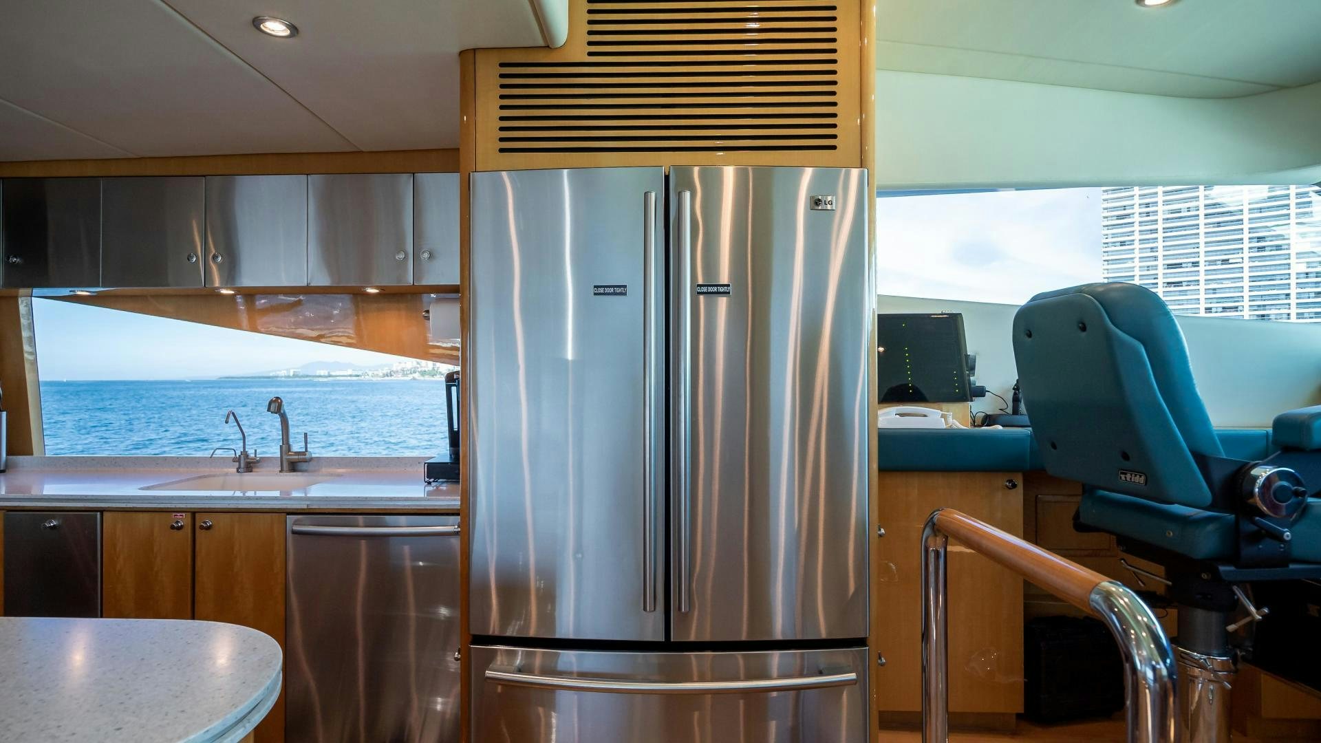 a stainless steel refrigerator in a kitchen aboard FULL HOUSE Yacht for Sale