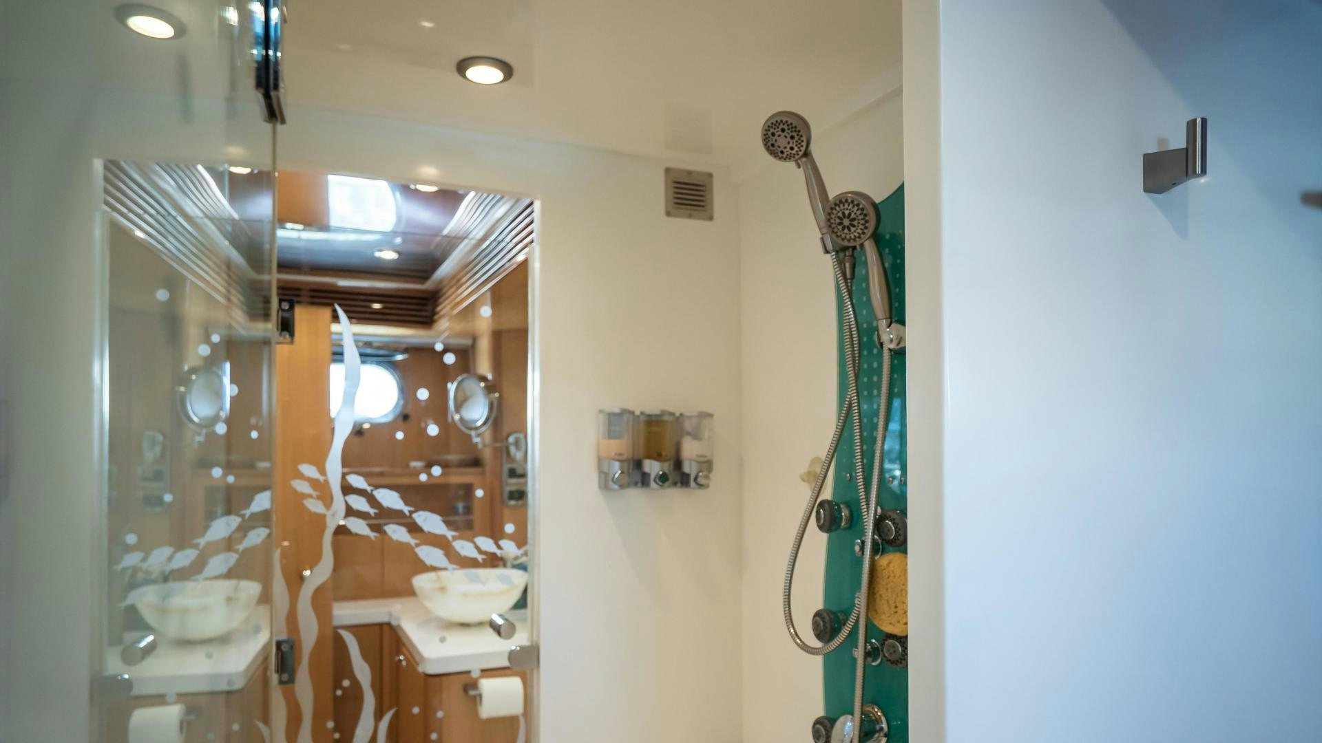a bathroom with a shower and sink aboard FULL HOUSE Yacht for Sale