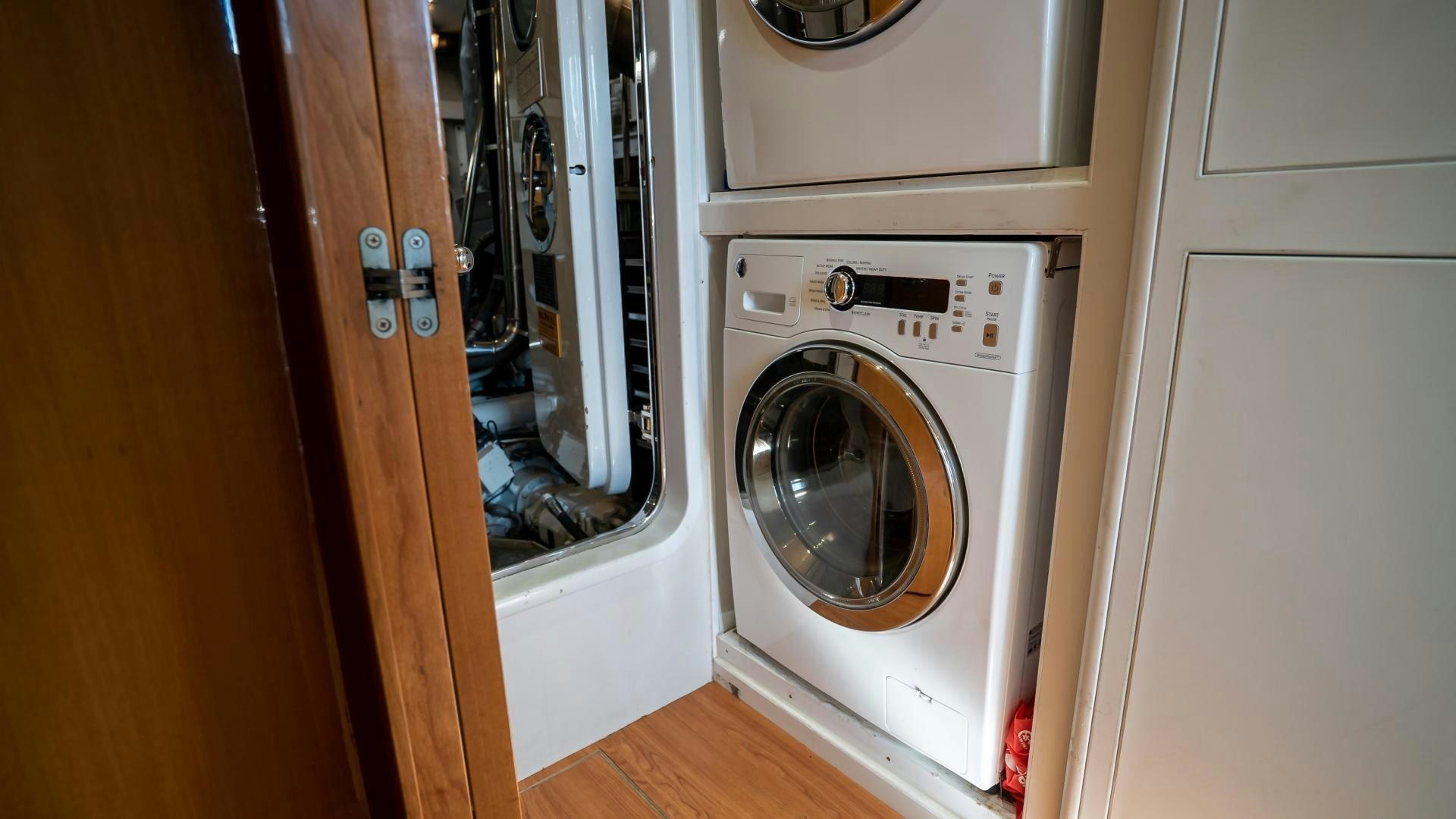 a washer and dryer in a closet aboard FULL HOUSE Yacht for Sale