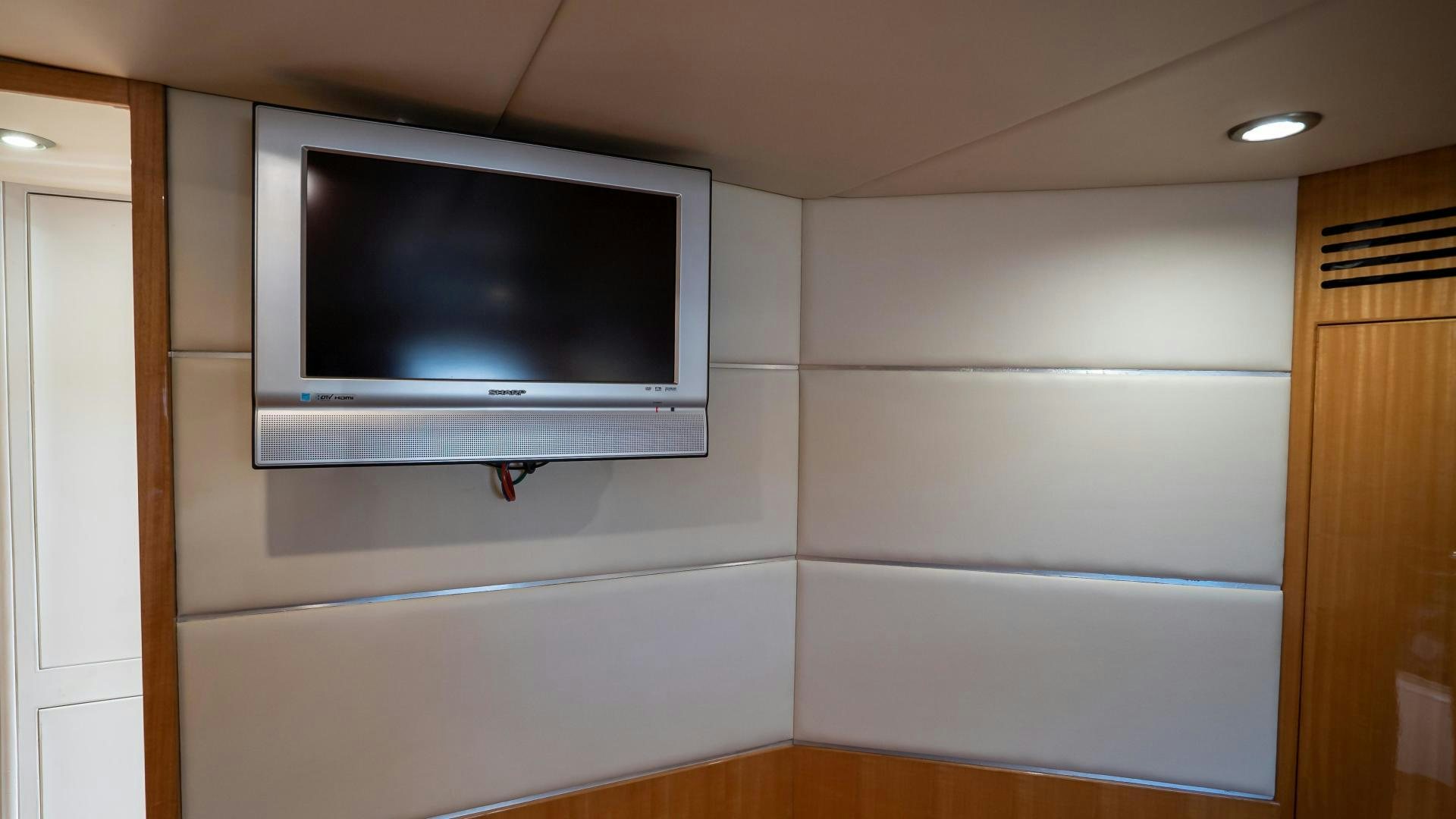 a tv on a wall aboard FULL HOUSE Yacht for Sale