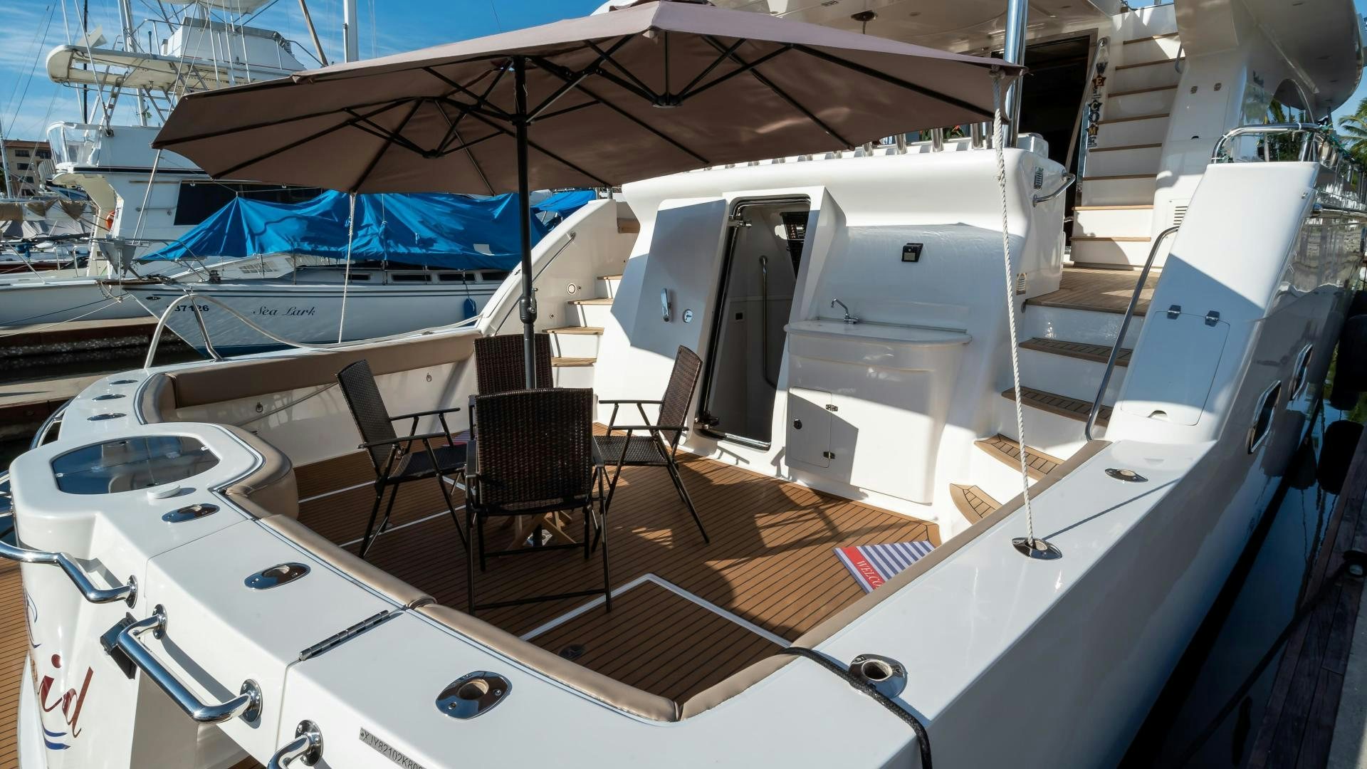 a boat with a deck and chairs aboard FULL HOUSE Yacht for Sale