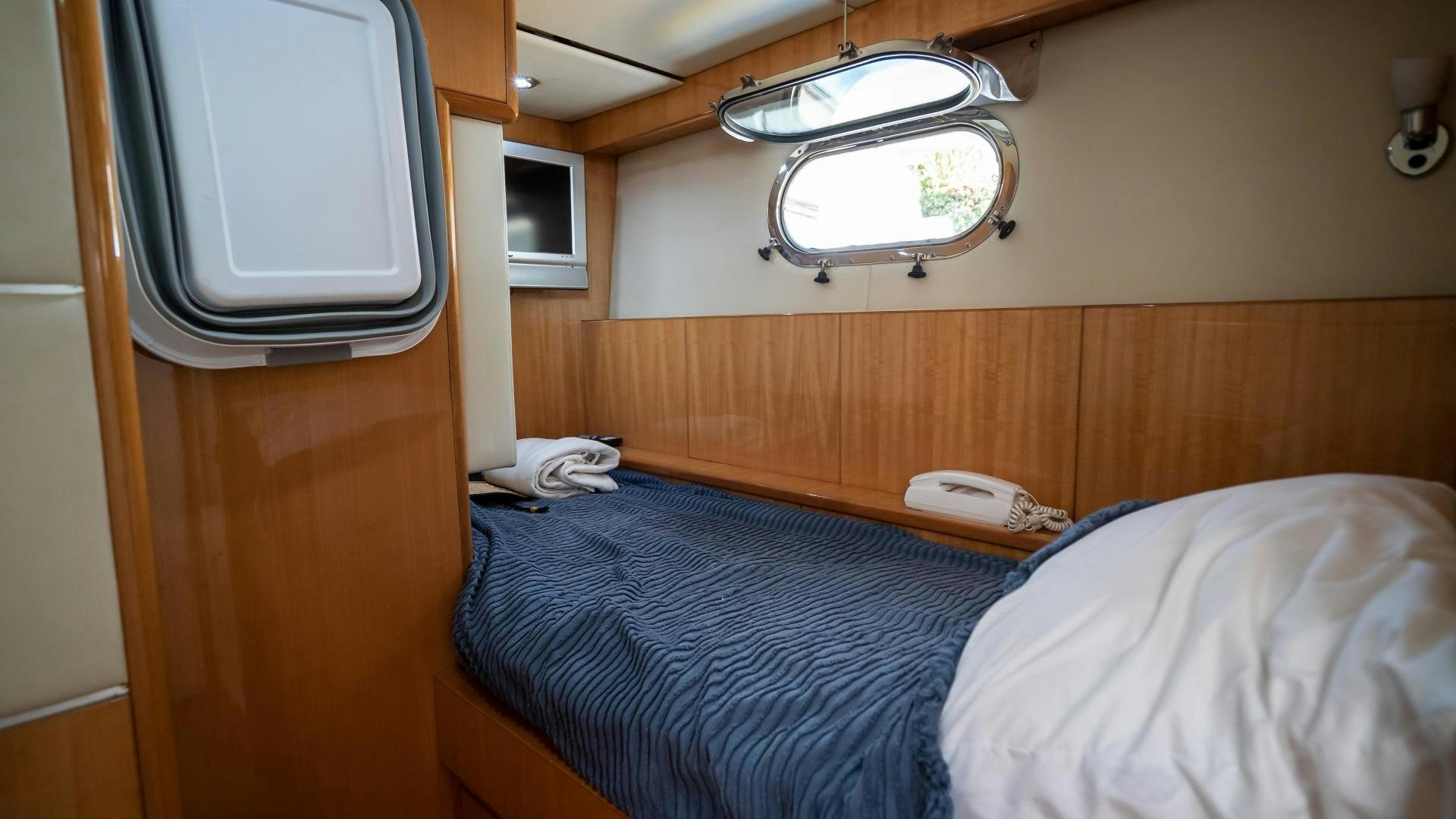 a bed with a blue blanket aboard FULL HOUSE Yacht for Sale