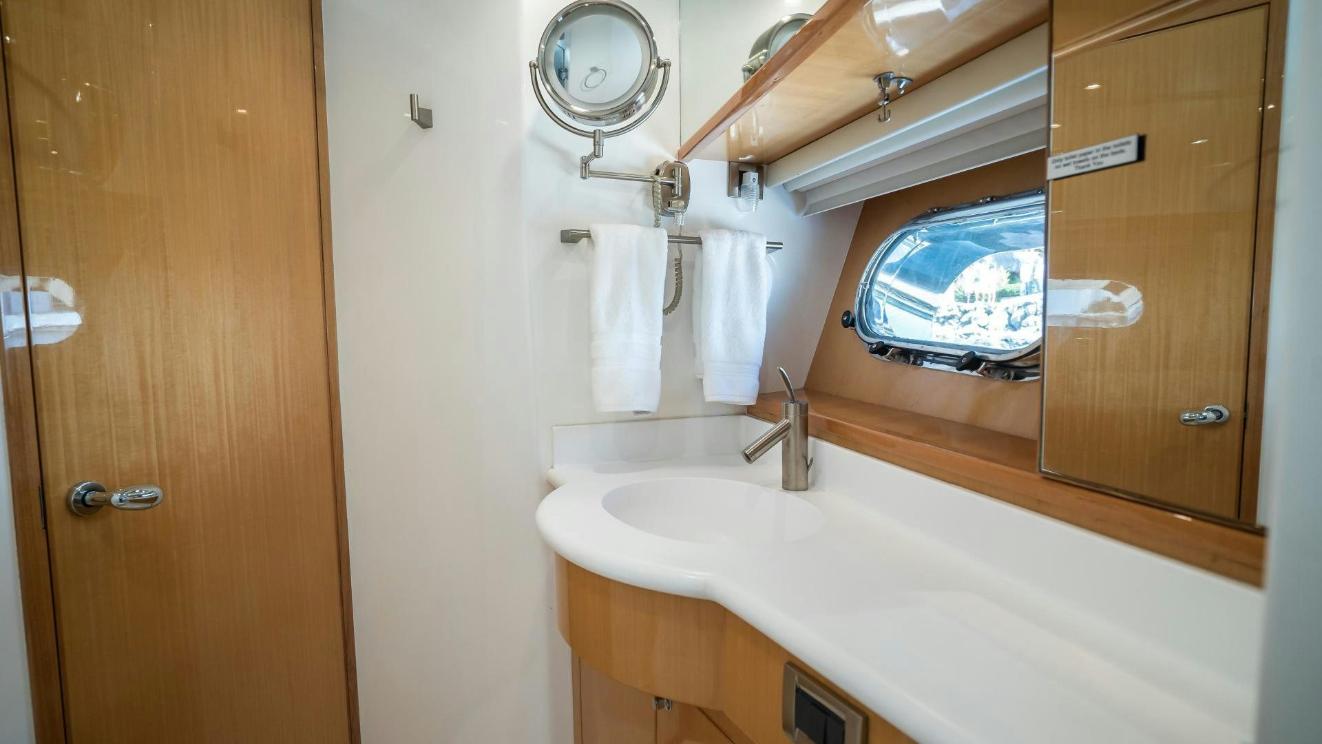 a bathroom with a sink and a mirror aboard FULL HOUSE Yacht for Sale