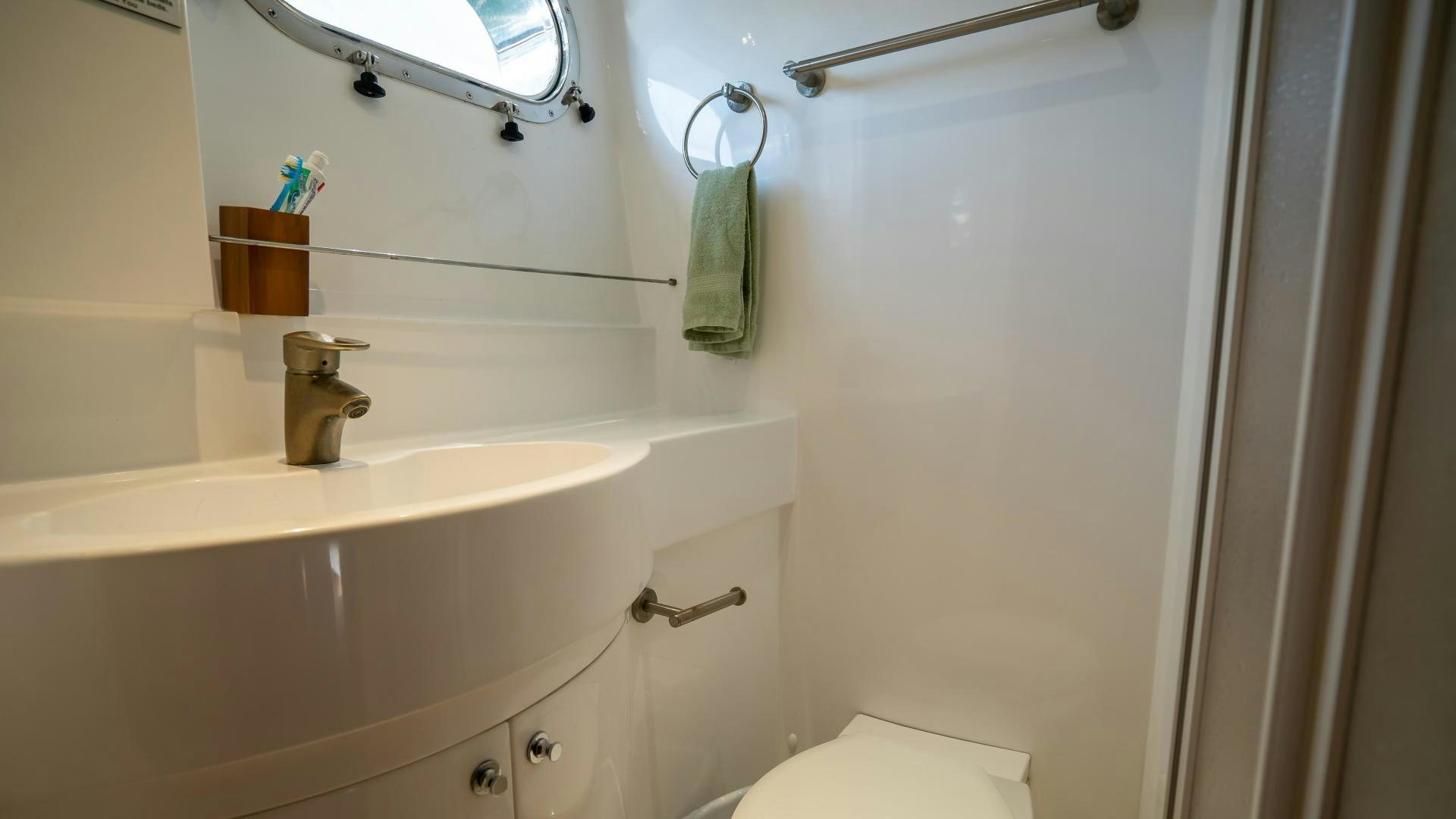 a bathroom with a sink and a toilet aboard FULL HOUSE Yacht for Sale