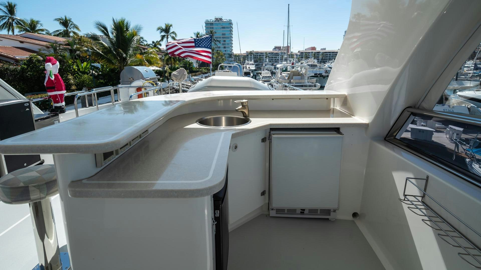 a large white boat with a red and white flag on the side aboard FULL HOUSE Yacht for Sale