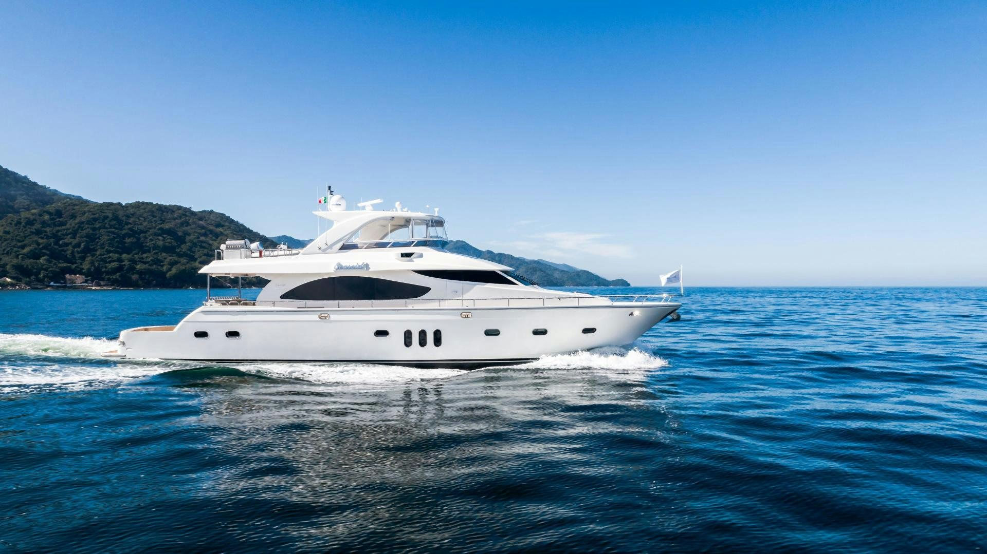 a white yacht on the water aboard FULL HOUSE Yacht for Sale
