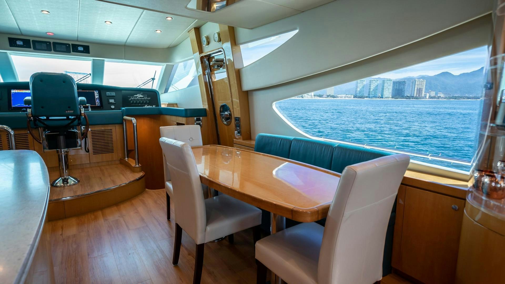 a room with a table and chairs aboard FULL HOUSE Yacht for Sale