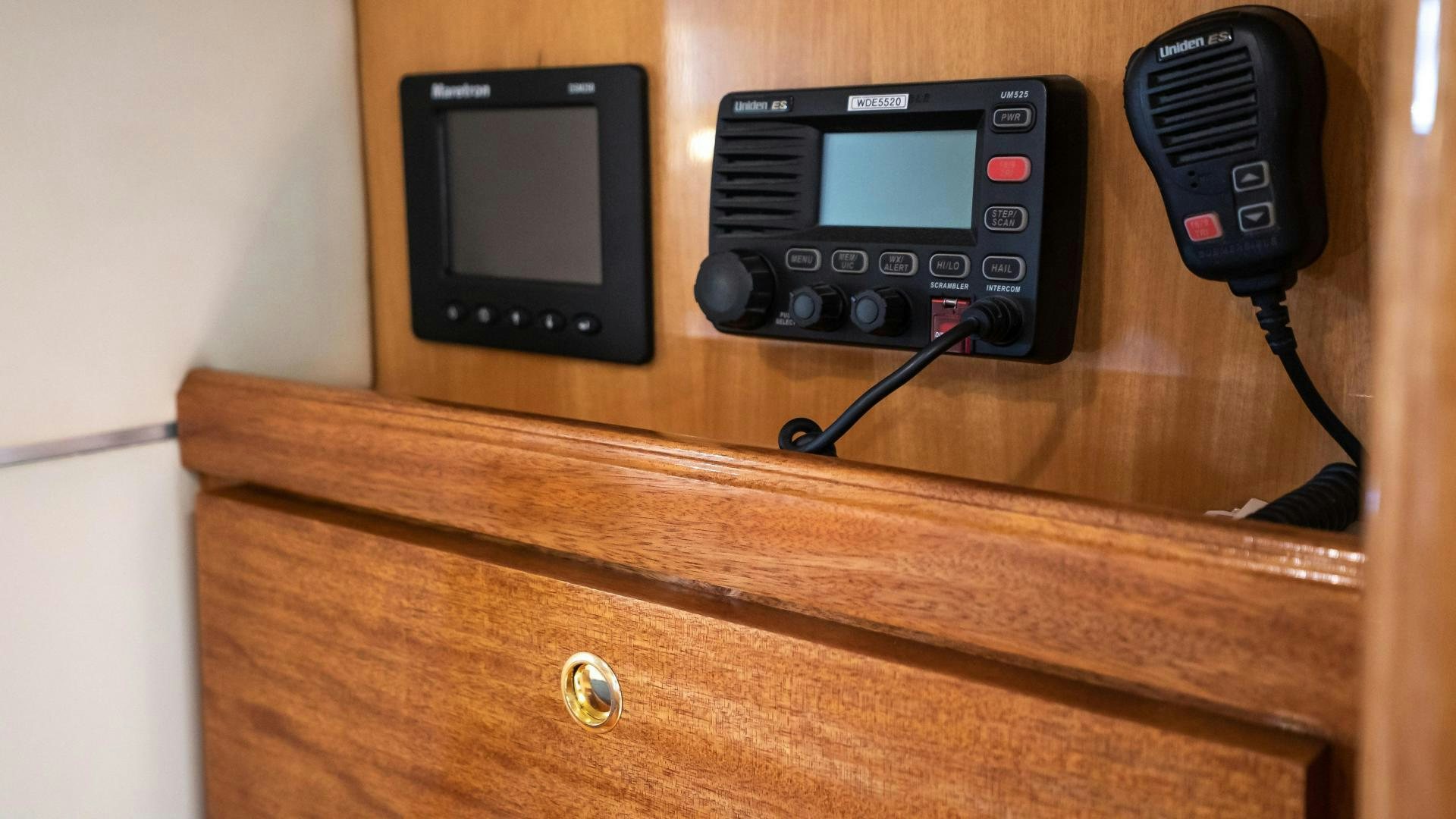 a black device on a wooden cabinet aboard FULL HOUSE Yacht for Sale
