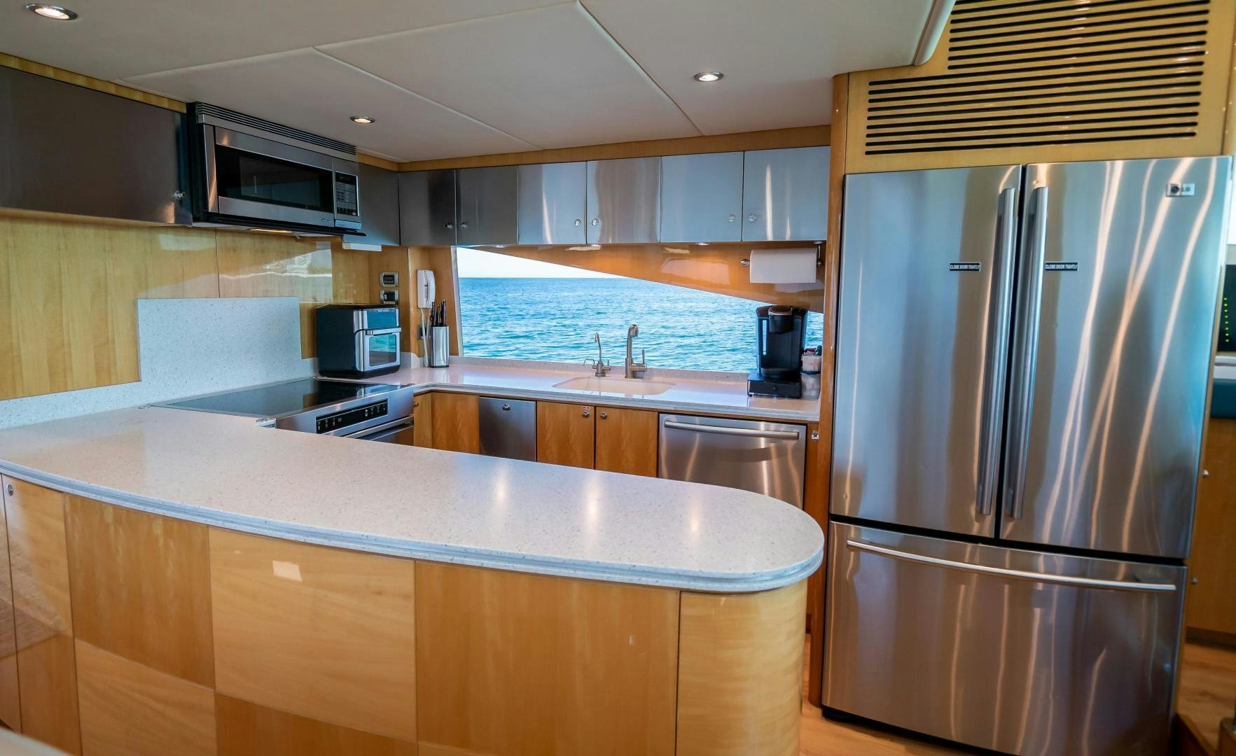 a kitchen with a stainless steel refrigerator aboard FULL HOUSE Yacht for Sale