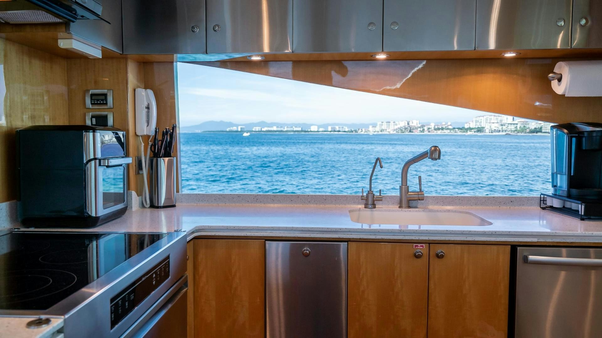 a kitchen with a large window aboard FULL HOUSE Yacht for Sale