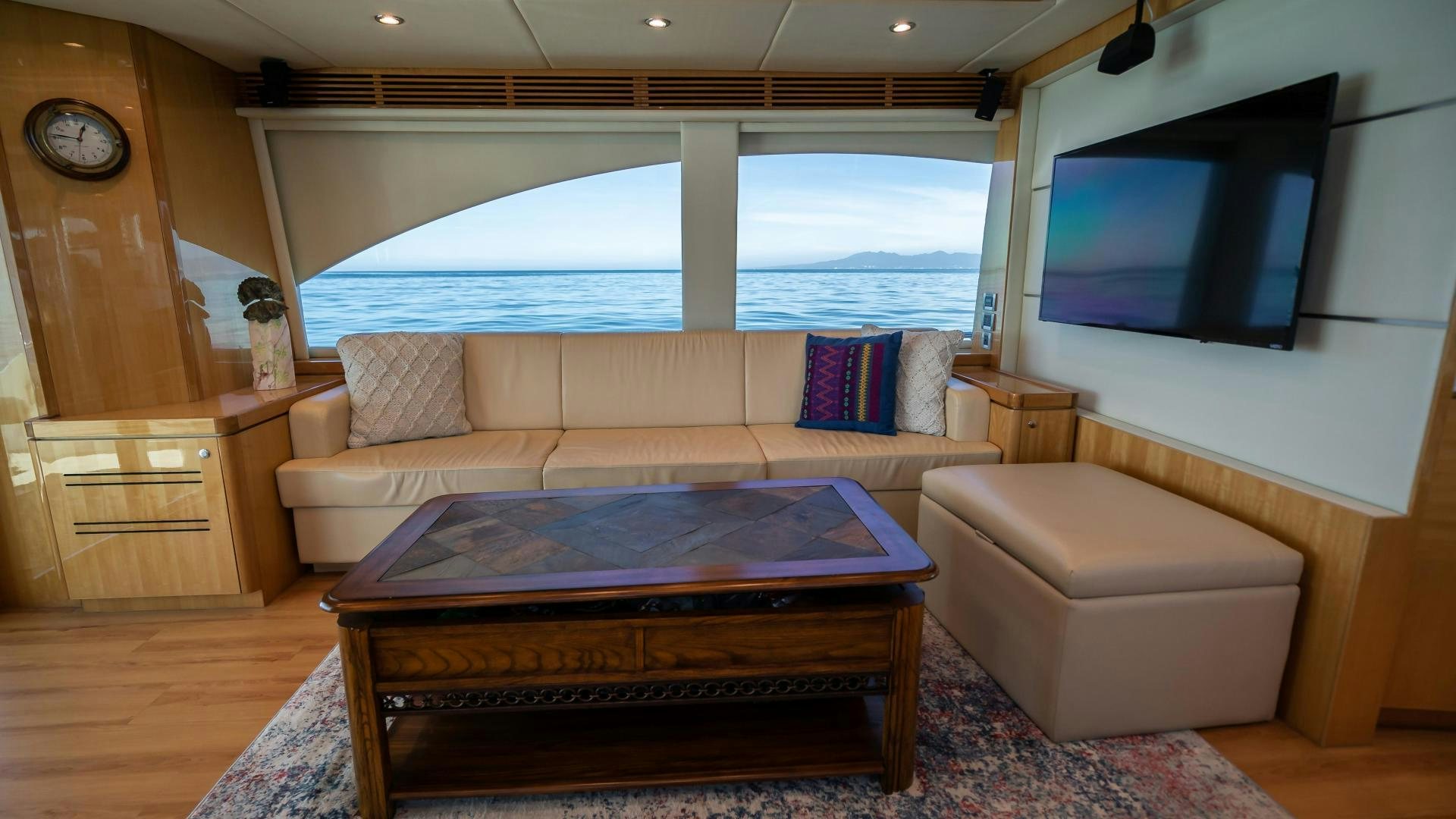 a living room with a large flat screen television and a large window aboard FULL HOUSE Yacht for Sale
