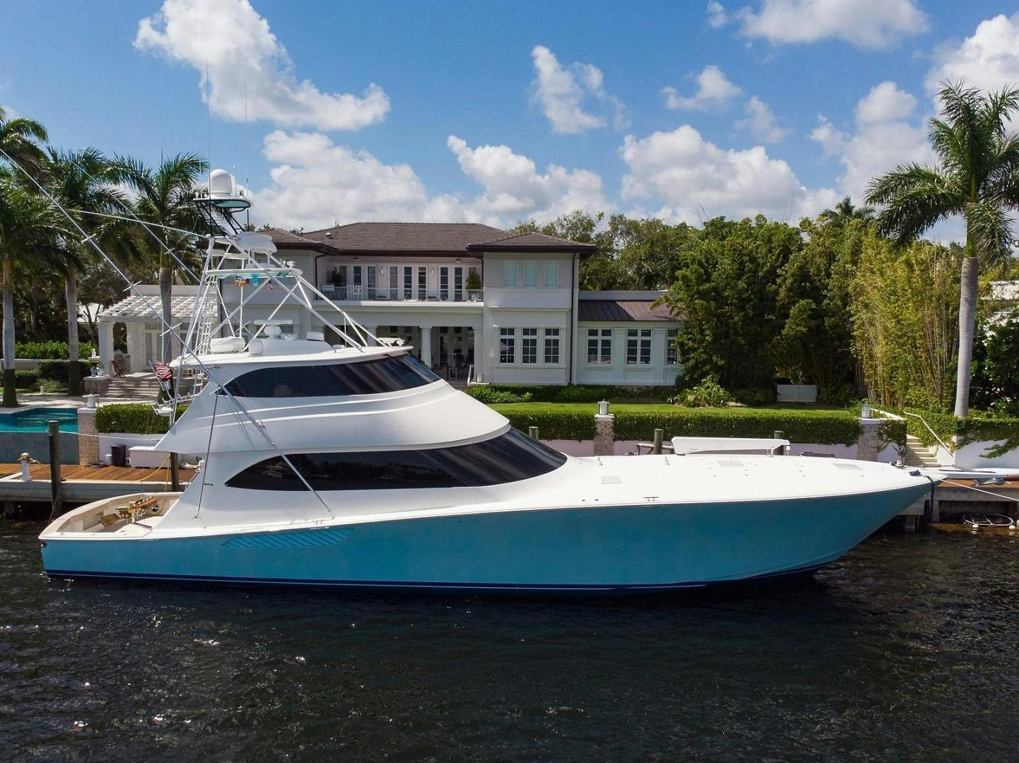 a boat docked in front of a house aboard NO NAME 82 Yacht for Sale