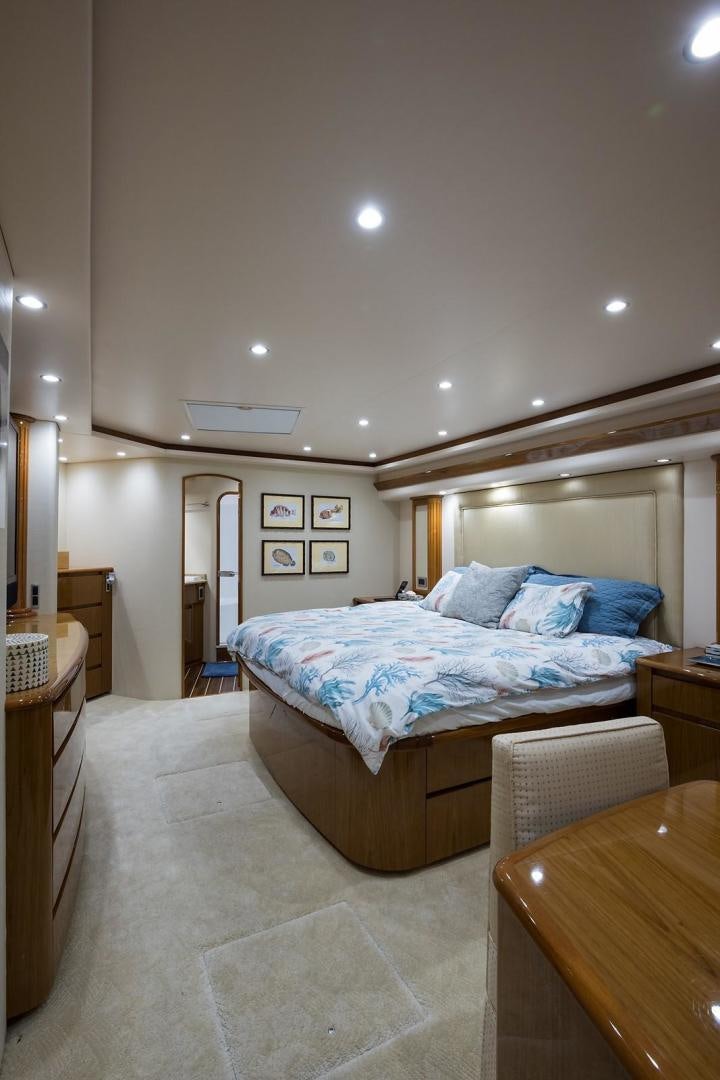 a bedroom with a bed and a table aboard NO NAME 82 Yacht for Sale