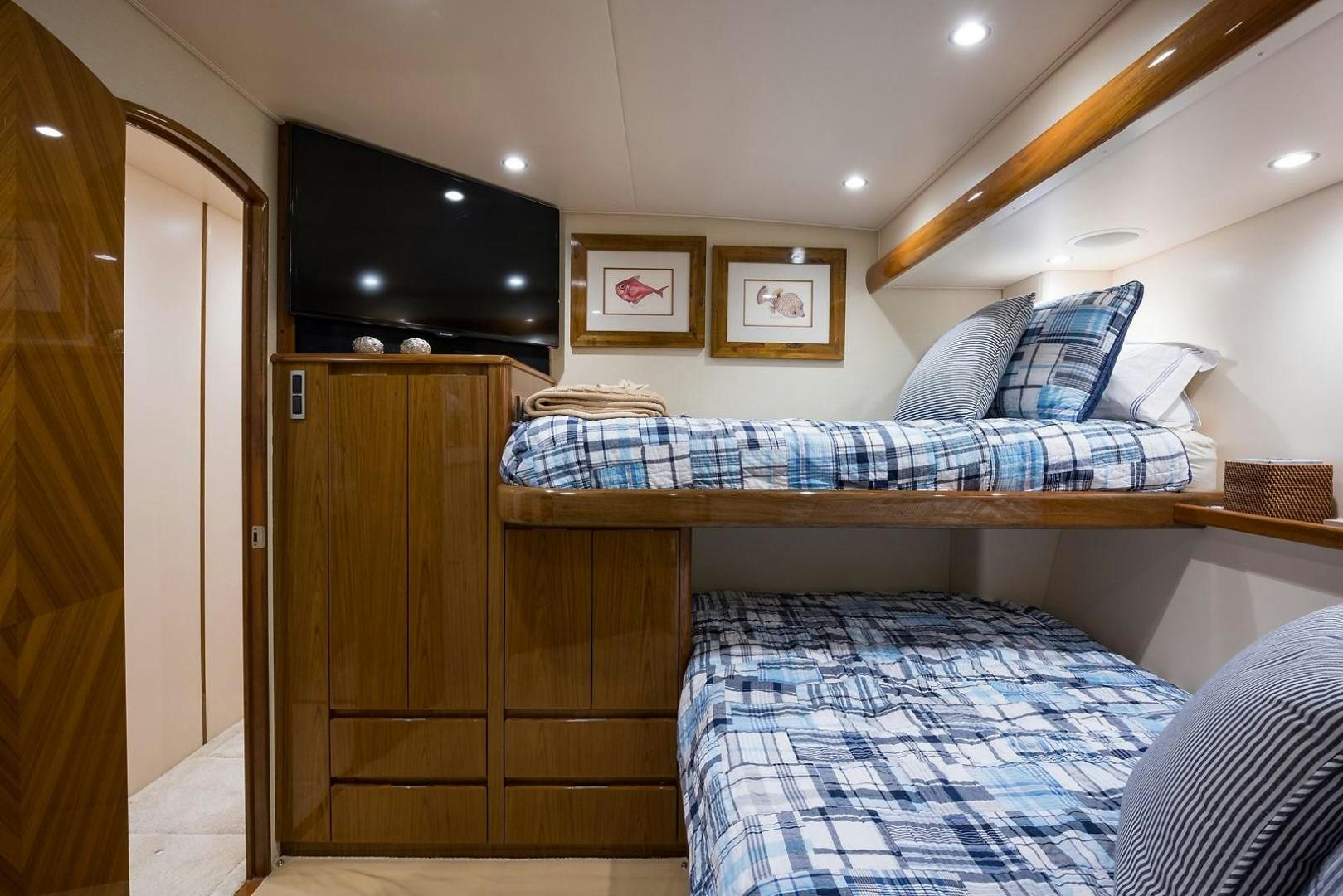a bedroom with a bed and a tv on the wall aboard NO NAME 82 Yacht for Sale