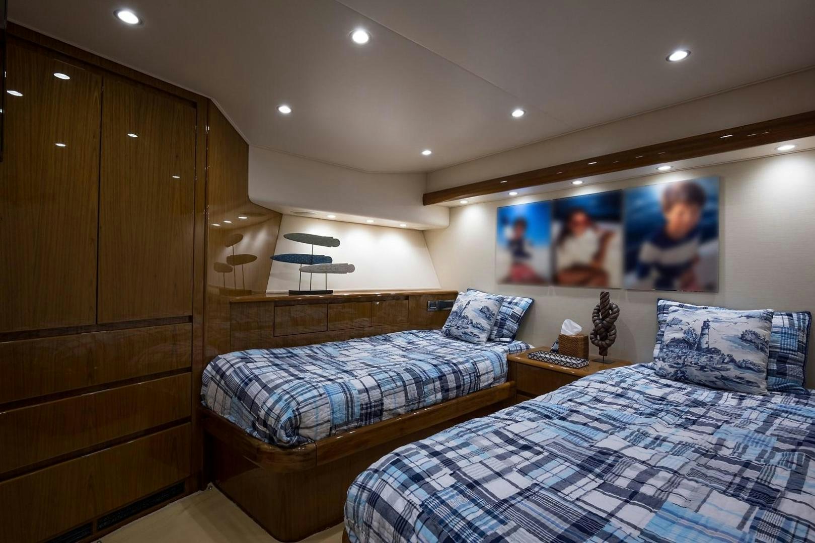 a bedroom with a bed and a wood cabinet aboard NO NAME 82 Yacht for Sale