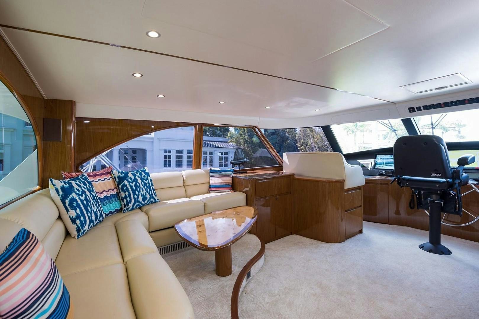 a living room with a large sofa and a large window aboard NO NAME 82 Yacht for Sale