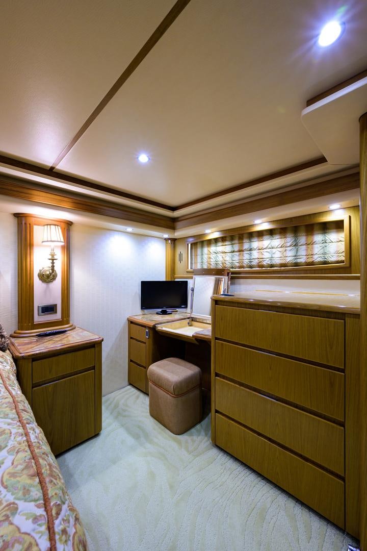 a bedroom with a desk and a computer aboard RITE ANGLER Yacht for Sale